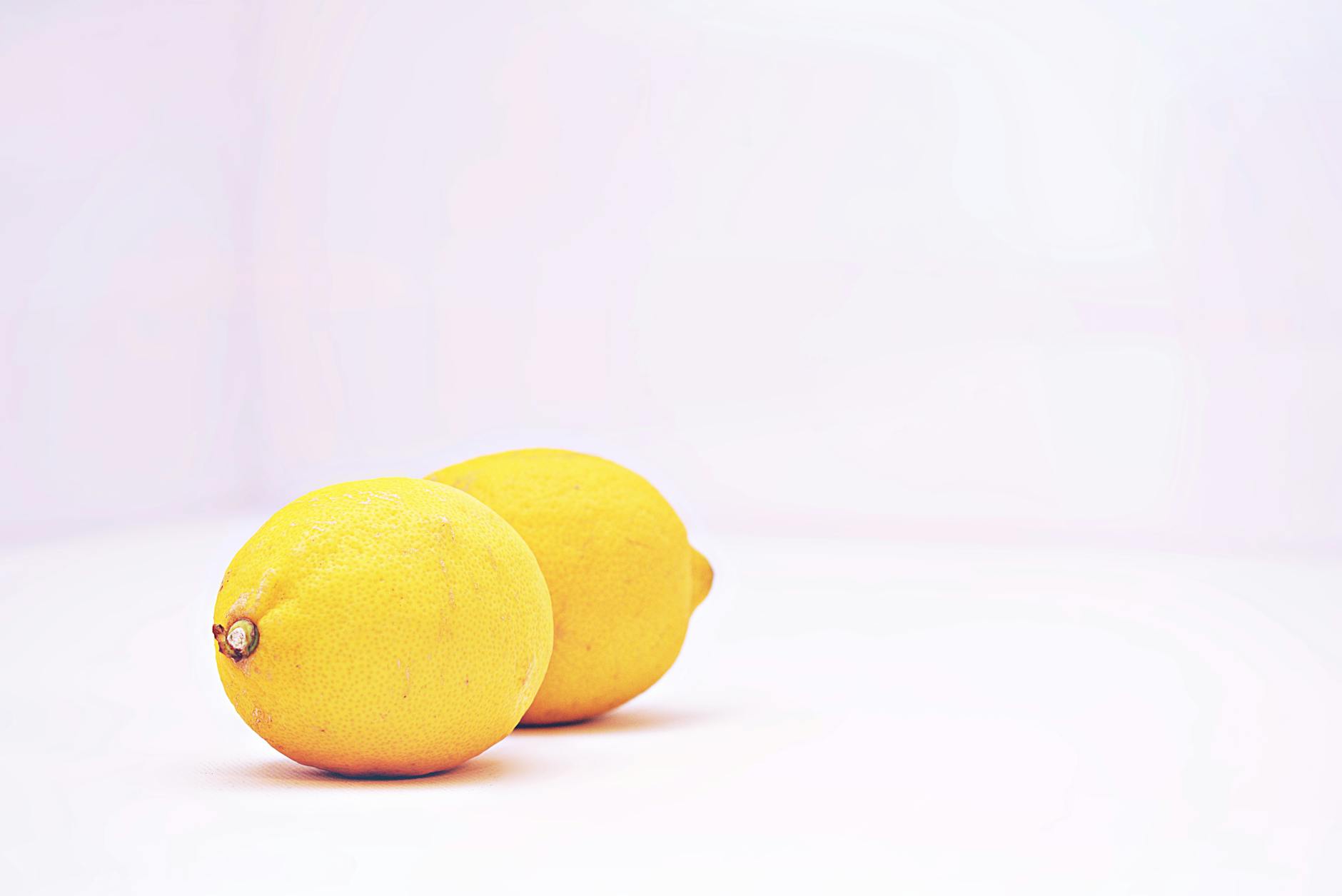 Two vibrant lemons against a white background symbolizing fresh recovery and sensation